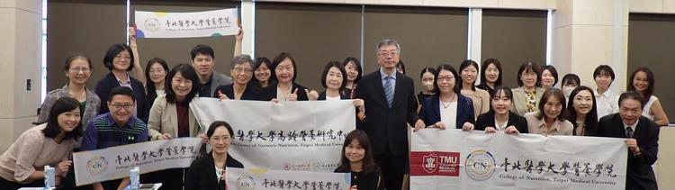 Picture with all the people at the hall after the conference